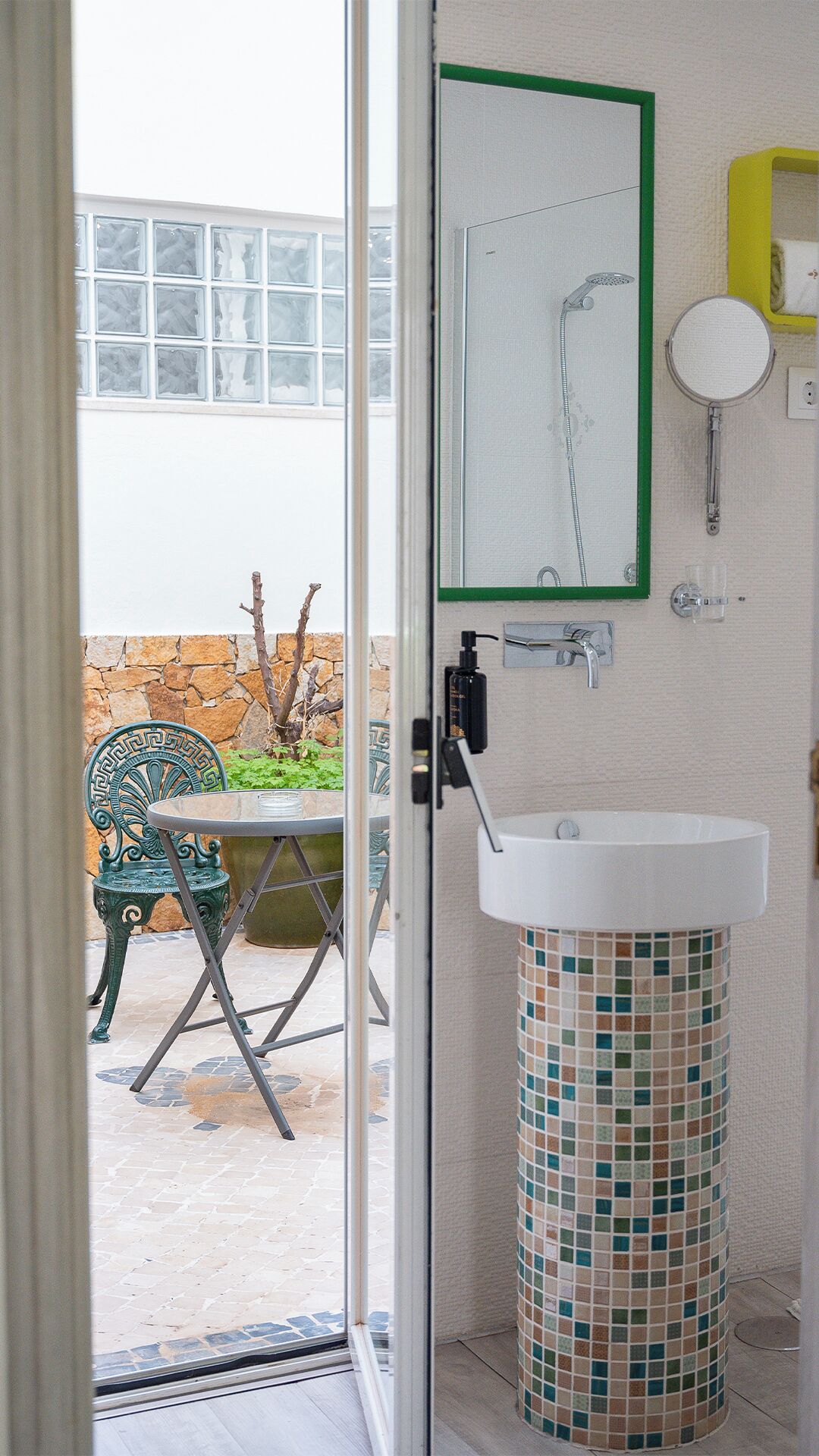 A bathroom with a white sink, a mirror, and a small window.