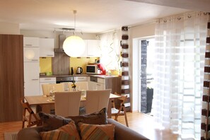 Comfort appartement | Privékeuken | Een koelkast met diepvriezer, een microgolfoven, een kookplaat