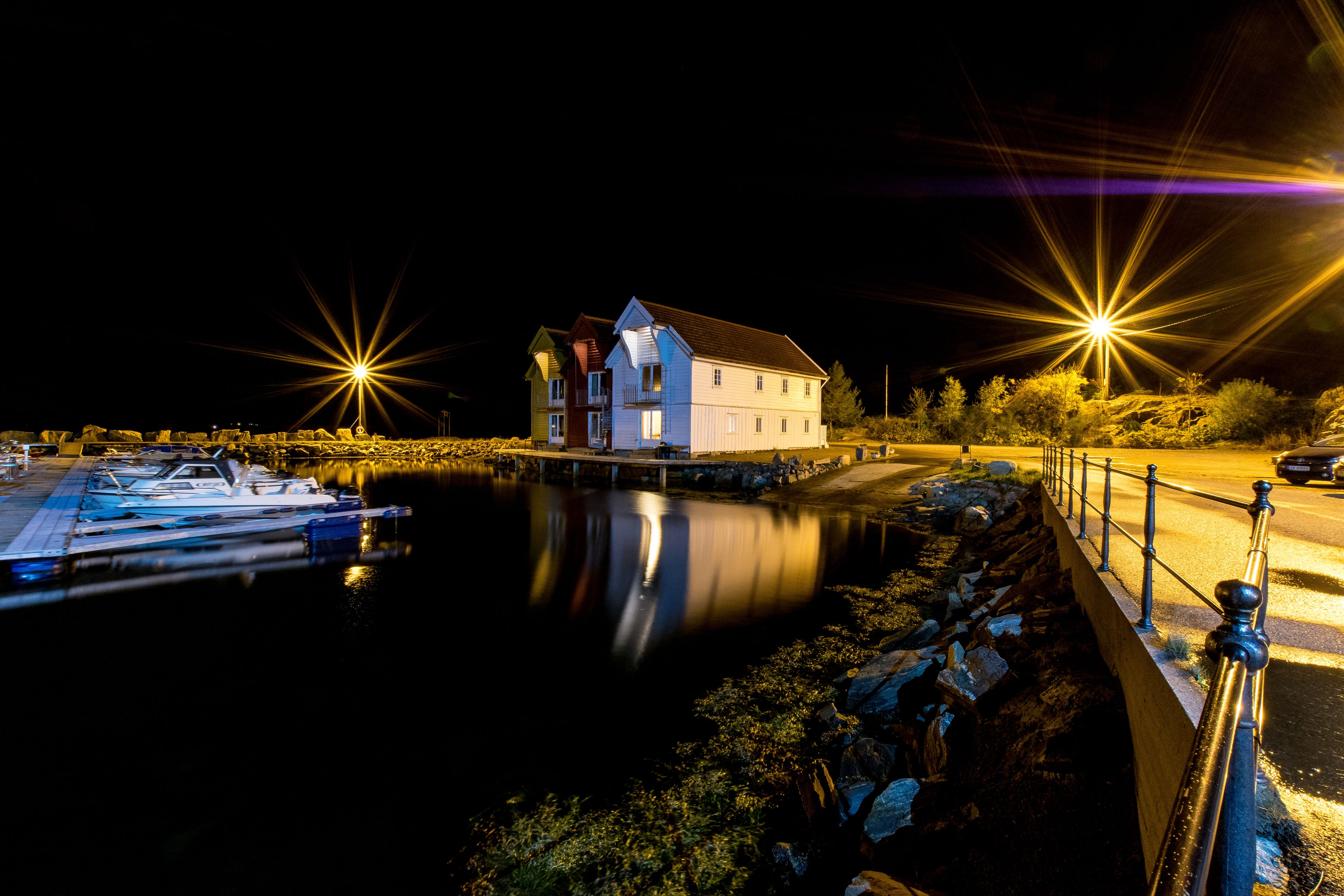A waterfront property with a house, dock, and boats.