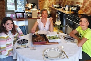 A dining table with plates, cutlery, and food.
