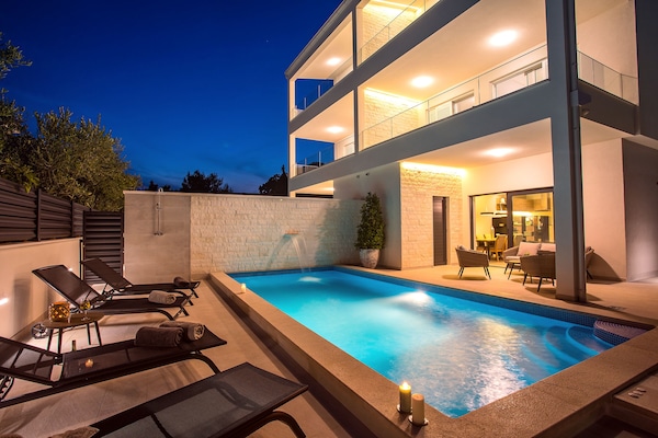 Seafront Villa Petra in the evening with beautiful lights & heated Pool