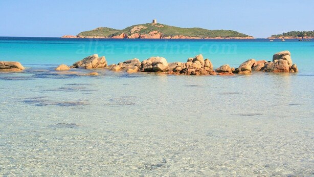 A coastal scene with clear turquoise water, rocky formations, and a hill with a structure on top. - studio 2/3 people with porto vecchio pool (Porto-Vecchio)