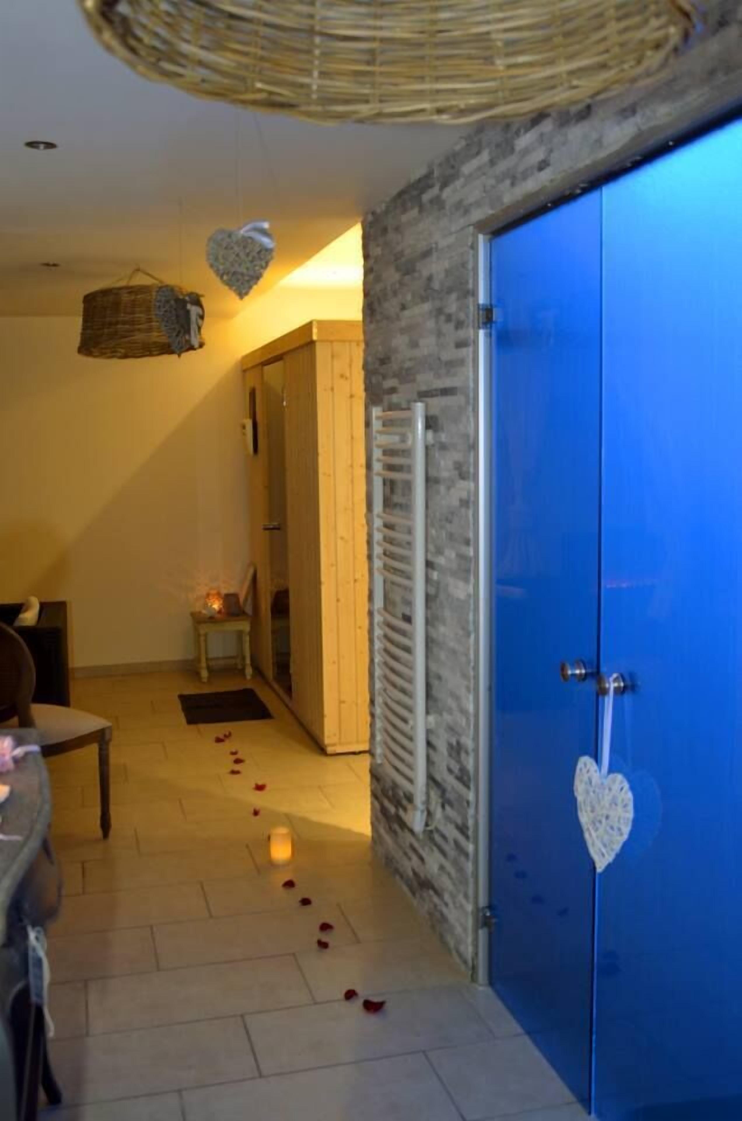 A room with a blue door, a wicker basket, and a heart-shaped decoration.