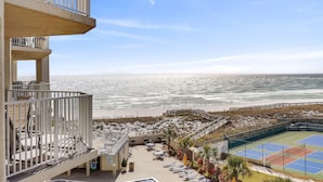 A beachfront hotel with a pool, outdoor seating, and a tennis court. - Inlet Reef 411 2 Bedroom Condo by RedAwning (Destin)
