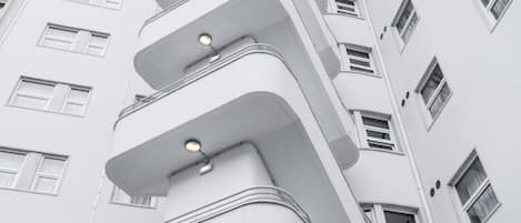 A modern building with multiple balconies and windows.