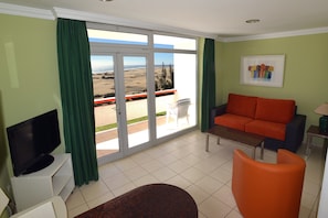 Apartment, 1 Bedroom, Balcony, Pool View | Living area | Flat-screen TV