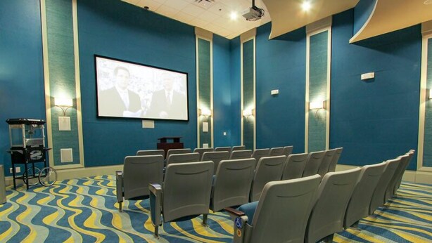 A conference room with rows of chairs facing a large screen. - Champions Gate 5 Bedroom House w Pool - 4912CG (Davenport)