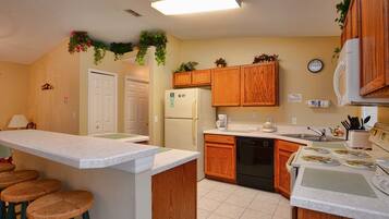 Full-sized fridge, dishwasher, cookware/dishes/utensils