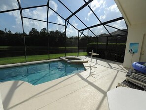 A covered outdoor swimming pool with a clear view of the surrounding landscape. - Cumbrian Lakes 634 (Kissimmee)