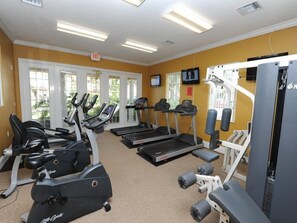 A gym with treadmills, elliptical machines, and weight machines. - Solana 21 (Davenport)