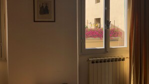 A room with a window, a radiator, and a framed picture on the wall. - Macci Number Eight (Florence)