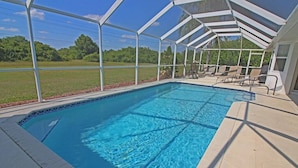 A covered swimming pool with a view of the surrounding landscape.