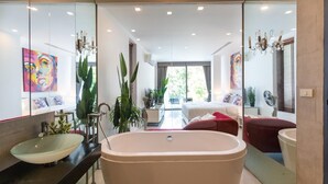 A modern bathroom with a freestanding bathtub, a large mirror, and a sink. - Villa 29/6 Ocean front pool villa (Tambon Patong)