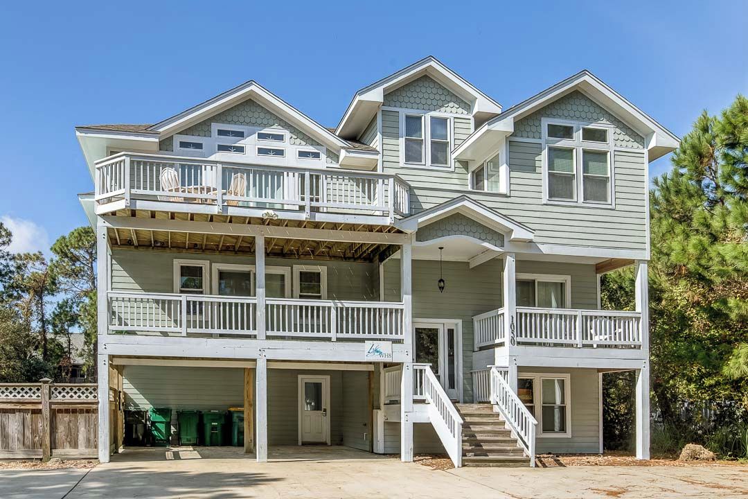 A two-story house with a covered front porch and a garage.