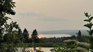 A natural landscape with a body of water, trees, and vegetation. - 27 Depot - Adorable 2 bedroom, 2 bath cottage close to the village (Rangeley)