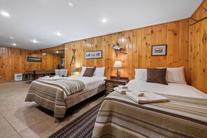 A hotel room with two beds, wooden walls, a mounted fish, and a framed picture. - Saddleback Lake Lodge 33 | Close to Saddleback (Rangeley)