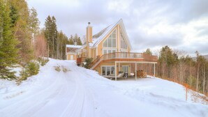 A modern house with a large deck and a steep driveway. - A Starry Night | Shared Waterfront | Close to Saddleback | Views (Rangeley)