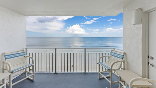 Direct oceanfront 2/2 with a private balcony, heated pool, and beach access