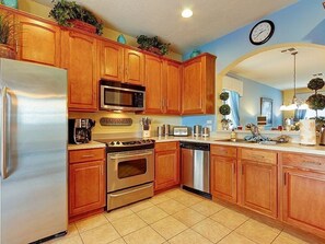 Equipped with a refrigerator, microwave, stove, and dishwasher, this kitchen offers a toaster and coffee maker.