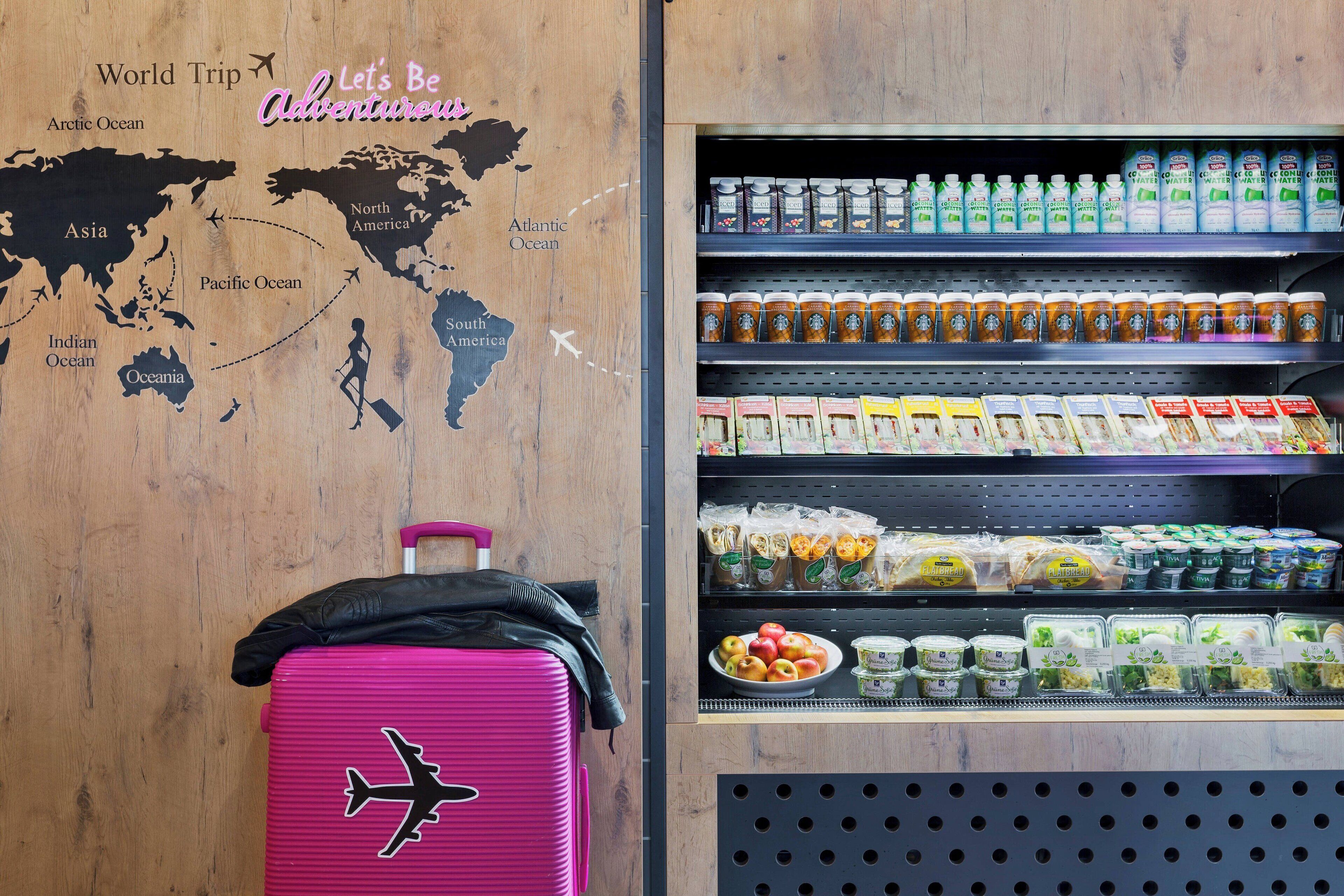 A travel-themed wall with a world map and a suitcase with an airplane design.