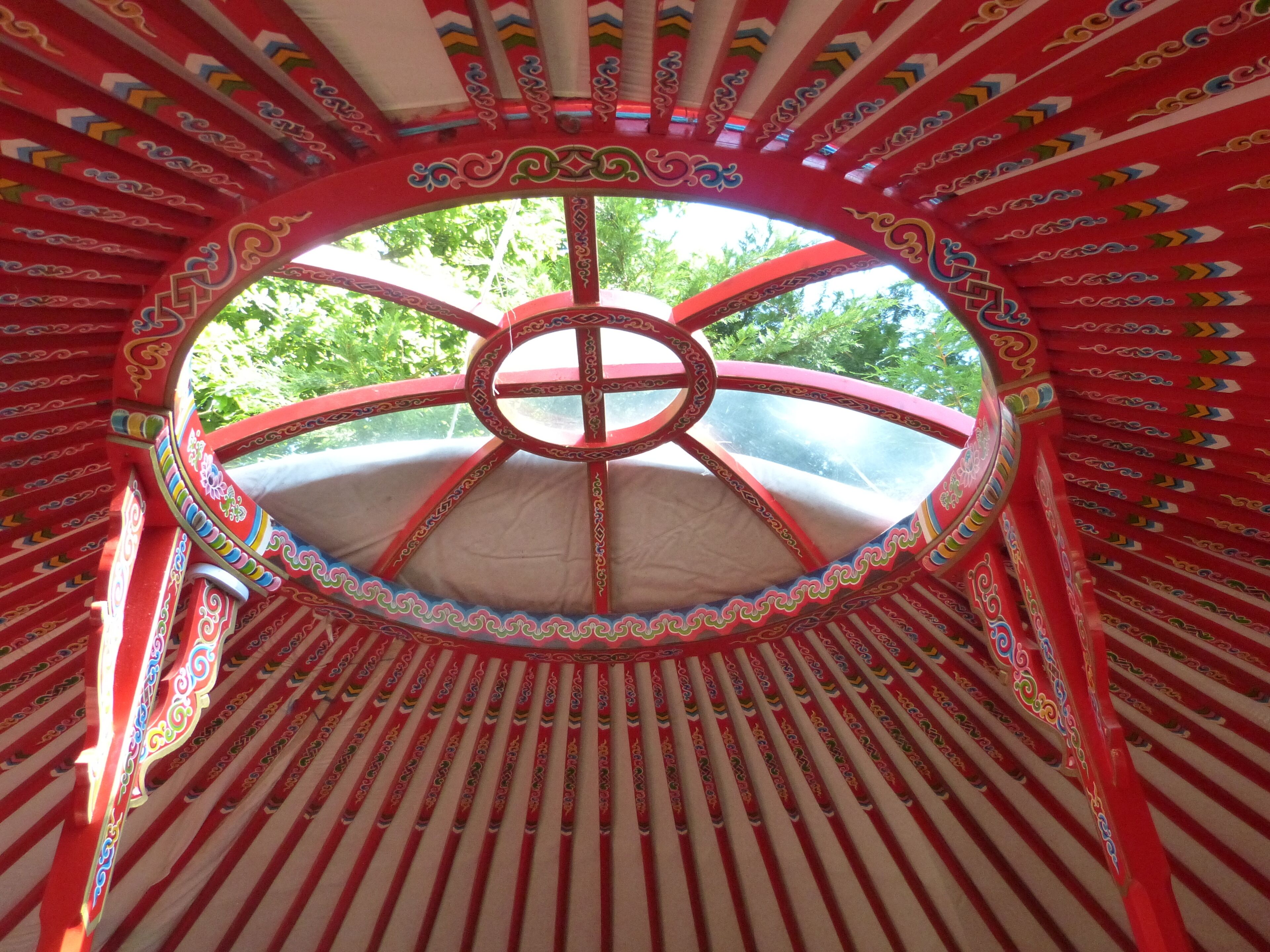 A circular structure with a central wheel design, surrounded by red and white striped patterns.