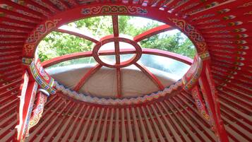 A circular structure with a central wheel design, surrounded by red and white striped patterns.