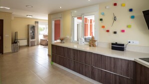 A modern kitchen with a wooden cabinet, a built-in oven, and a window with a view of the outside. - Stunning Villa - Open Plan & Heated 8m Pool  (Torre-Pacheco)