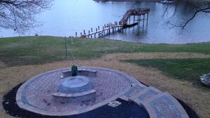 A circular outdoor area with a central fire pit, surrounded by a brick walkway. - Mountain Style Log Home Main Channel/Patio/Fire Pit/Lake Equipment Rental/Dock (Terrell)