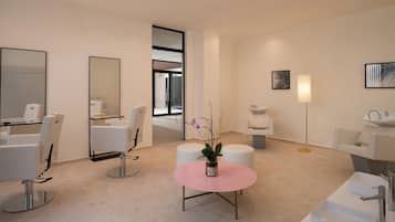 A modern hotel room with a large mirror, two white chairs, a pink table with a vase, and a large window.