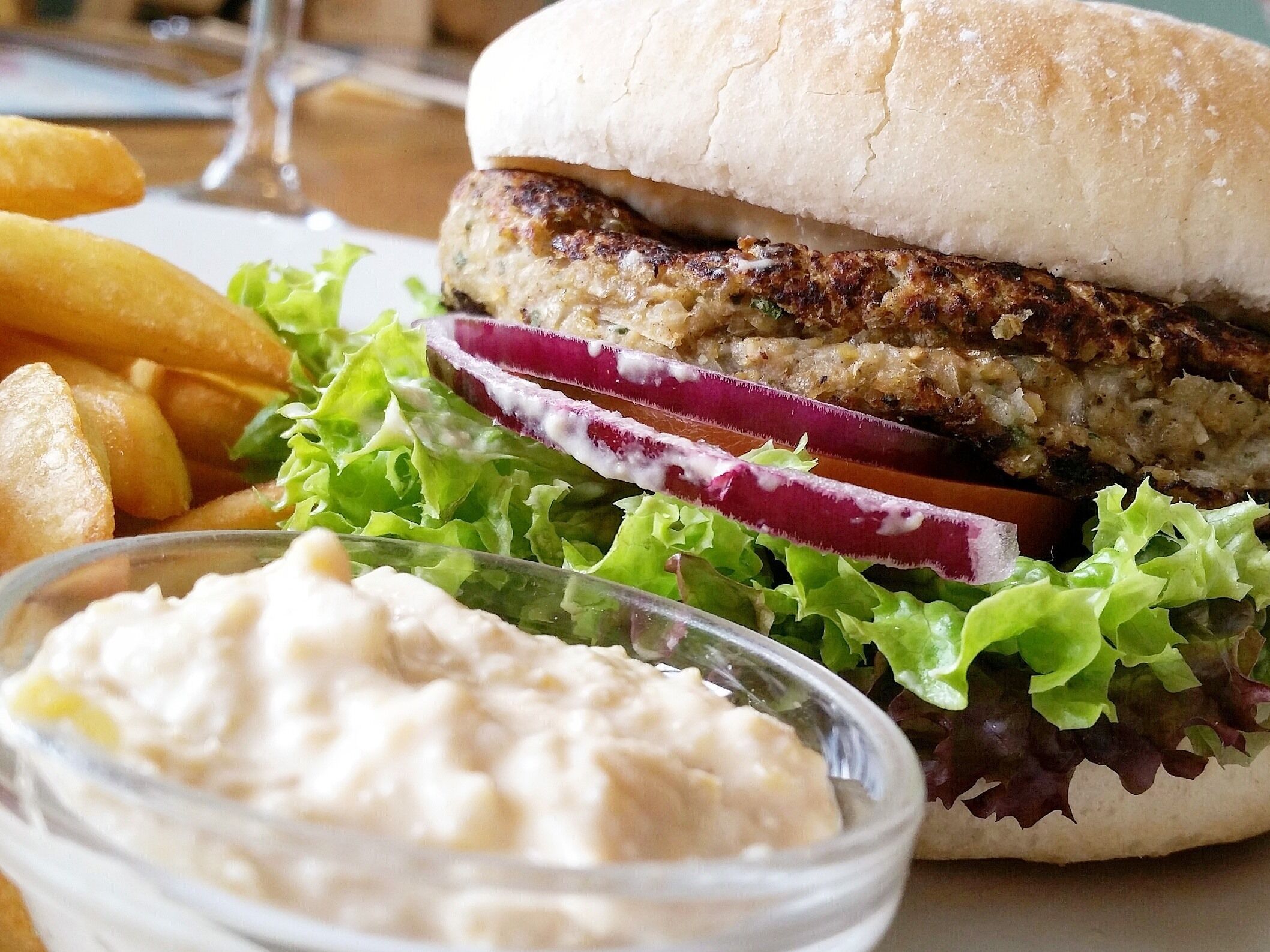 A burger with fries and a side salad.