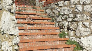 A set of stone steps leading up to a brick wall with a metal railing. - MBI Sunrise Waterfront Condo - Beautiful Lake Views (Middle Bass)