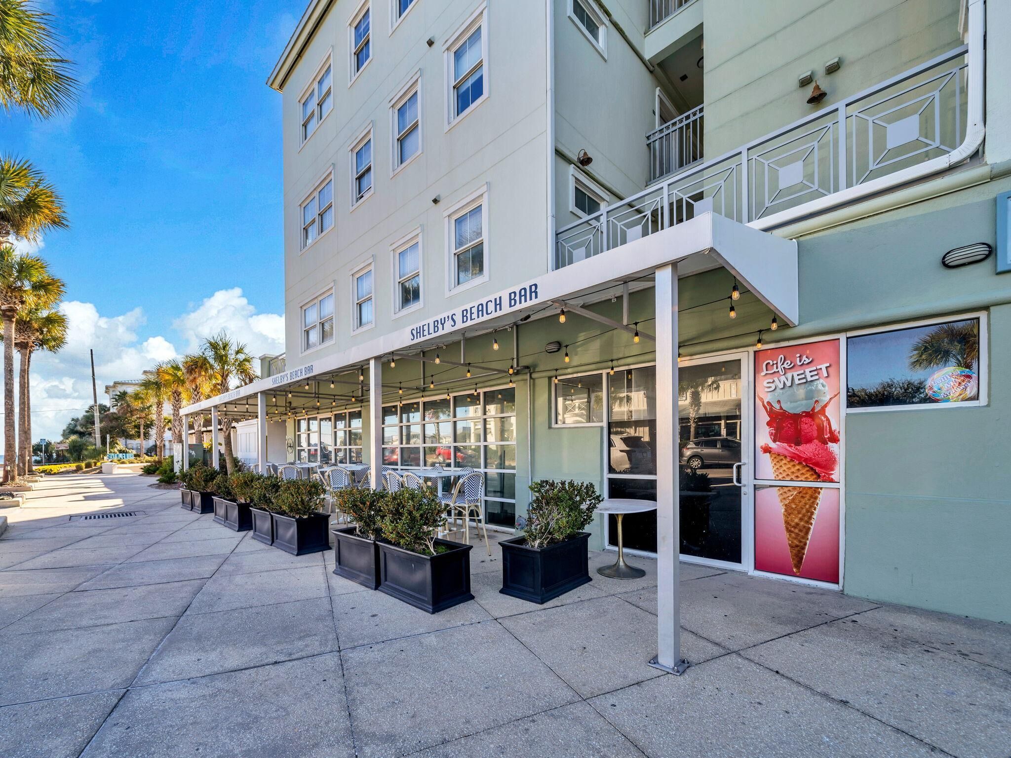 Shelby's Beach Bar with outdoor seating and a view of the street.