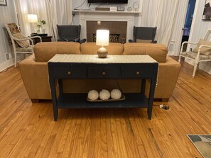 Relax in this inviting living room with a sofa, armchairs, and a coffee table.