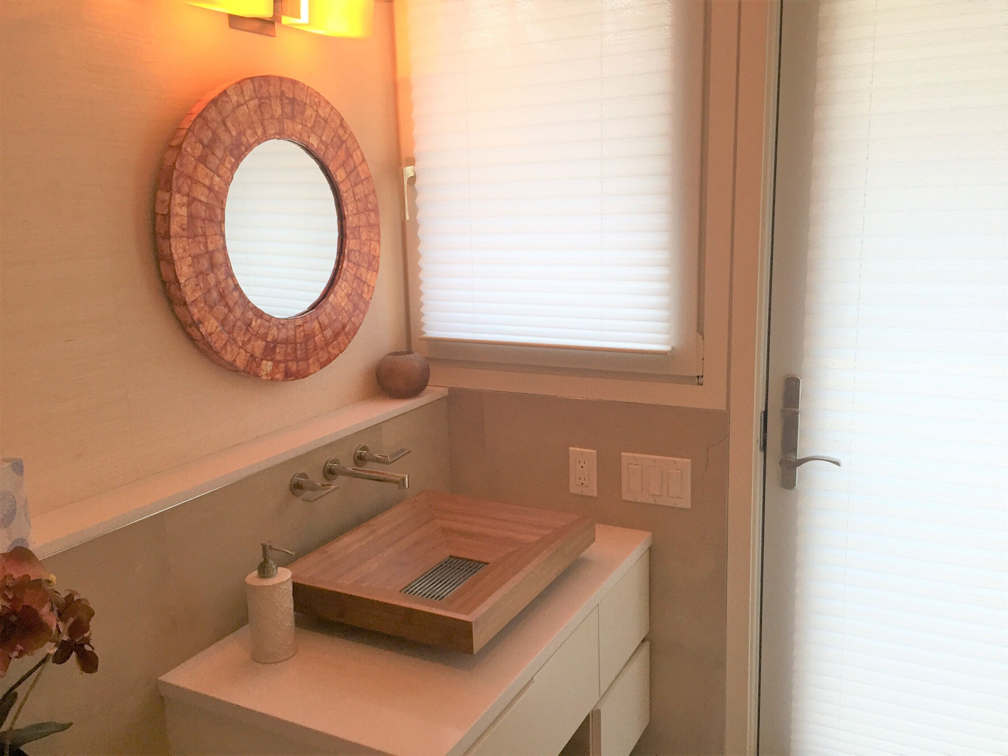 First floor powder room with entries from living room and pool