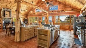 A spacious kitchen with wooden cabinets, a central island, and a large refrigerator.