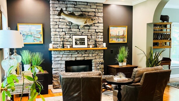 A modern living room with a stone fireplace, leather sofas, and a wooden floor. - NEWLY RENOVATED! 5-Star, Edgartown Colonial with Central AC (Edgartown)