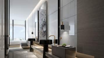 A modern bathroom with a long counter, two sinks, and a large mirror.