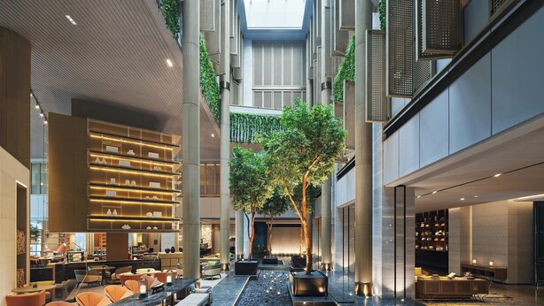A spacious indoor atrium with a central water feature, seating areas, and a modern design with a high ceiling and natural light. - Sheraton Shenzhen Nanshan (Shenzhen)