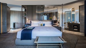 A modern hotel room with a large bed, bedside tables, a mirror, and a built-in wardrobe. - Sheraton Shenzhen Nanshan (Shenzhen)