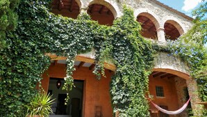 A building with multiple arches and a covered patio area. - Stunning property isolated, surrounded by nature, 5 min to beaches. Max privacy. (gualta)