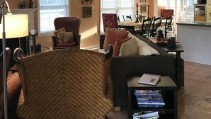 A spacious living room with a high ceiling, a dining area, and a staircase leading to an upper level. - Close to Beach! 2026 Prime Weeks Available!  Family Oriented Home! Dogs Welcome! (Bethany Beach)