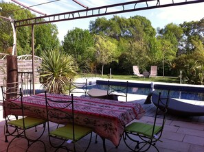 An outdoor patio with a pool, surrounded by greenery and trees. - beautiful property in the Aix countryside (Aix-En-Provence)