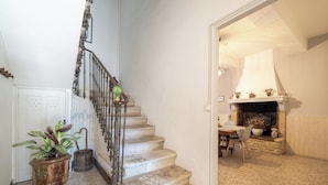 A staircase with a wrought iron railing leading to a room with a fireplace and a dining table. - MAS OF VILLAGE IN JONQUERETTES NEAR AVIGNON (Jonquerettes)