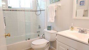 Shower, hair dryer, towels, toilet paper