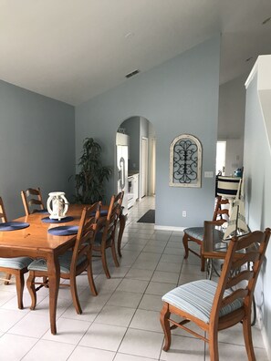Enjoy meals with friends and family in this cozy dining area, featuring a wooden table and six comfortable chairs.