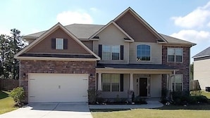 A two-story house with a garage, a front porch, and a brick facade. - New Listing! Fully furnished! Available for Master's!! (Augusta)