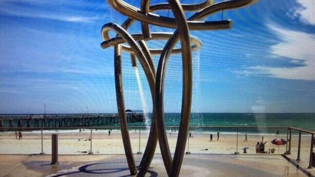 A metal sculpture on a beach with a pier in the background. - A Great Family Place in Henley Beach - Pets  ✅ opposite park stylish & comfy (Henley Beach)