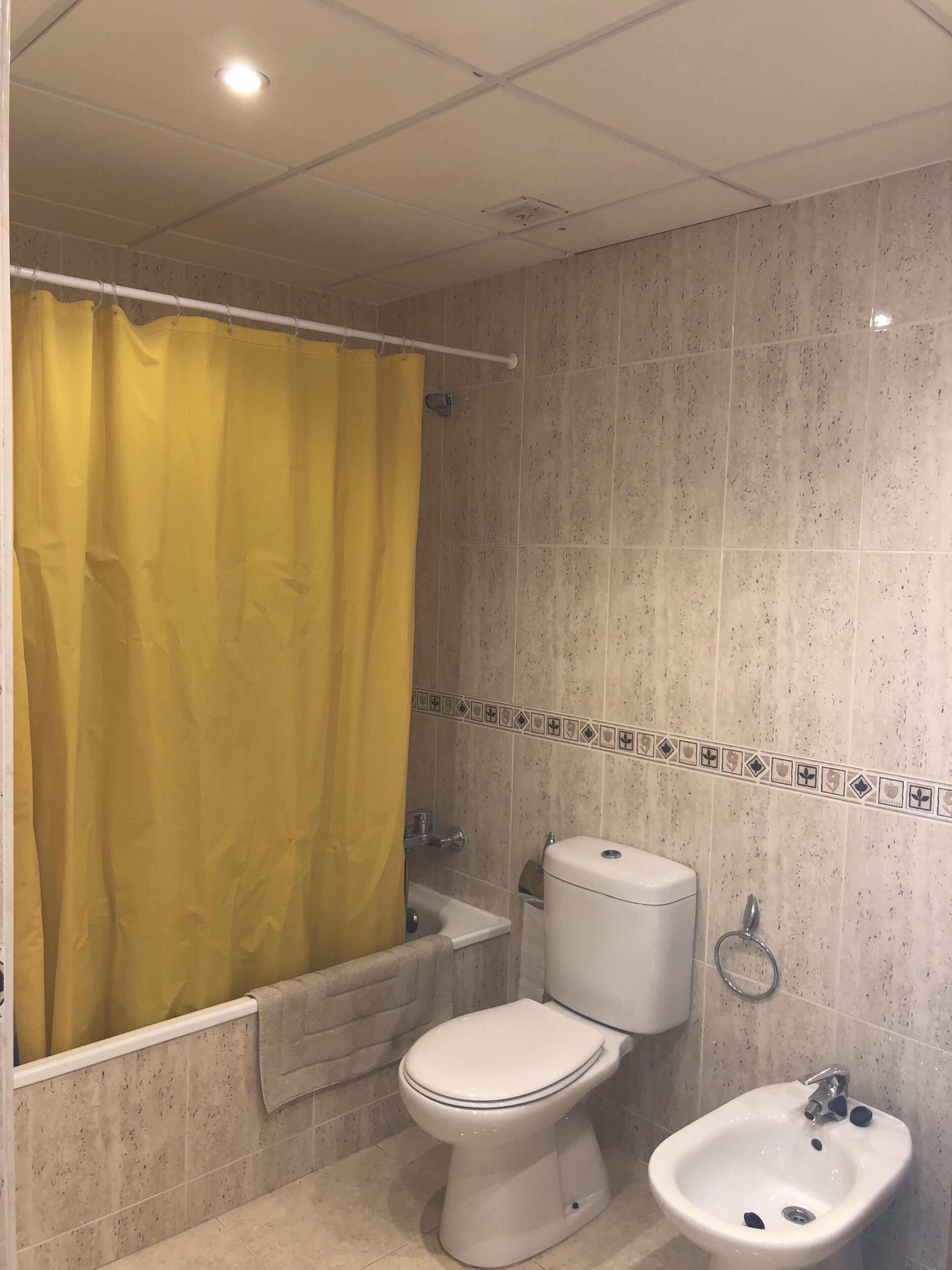 A bathroom with a toilet, bidet, and sink.