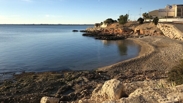 A coastal landscape with a rocky shoreline, calm water, and a clear sky. - COZY APARTMENT 50 M FROM THE BEACH with WIFI (L'Ampolla)