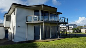 A two-story building with a balcony and a garage.